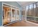 Inviting screened porch with access to the interior and views of the wooded backyard at 216 Copper Beech Ct, Chapel Hill, NC 27517