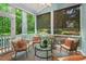 Cozy screened porch with outdoor seating, perfect for enjoying the surrounding lush greenery in comfort at 216 Copper Beech Ct, Chapel Hill, NC 27517