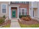 Inviting front entry with a green door, brick accents, and manicured landscaping at 222 Grey Elm Trl, Durham, NC 27713