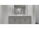 Bathroom showcasing double vanity and a large mirror at 258 Palm Dr, Sanford, NC 27332