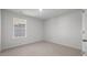 Carpeted bedroom with a window and white walls offering a bright, neutral space at 258 Palm Dr, Sanford, NC 27332