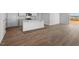 Modern kitchen featuring granite countertops, an island with sink, and wood-look flooring at 258 Palm Dr, Sanford, NC 27332
