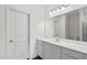 Bright bathroom featuring a long vanity with a sink, large mirror, and modern lighting at 260 Logan Creek Dr, Zebulon, NC 27597