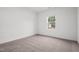 Neutral bedroom with plush carpet and a bright window offering natural light at 260 Logan Creek Dr, Zebulon, NC 27597