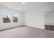 Bright, empty bedroom featuring large windows and neutral carpet flooring at 260 Logan Creek Dr, Zebulon, NC 27597