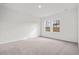 Bright, empty bedroom with large windows and neutral carpeting at 260 Logan Creek Dr, Zebulon, NC 27597