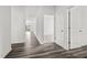 Bright hallway showcasing durable wood flooring and access to various rooms within the home at 260 Logan Creek Dr, Zebulon, NC 27597