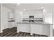 Well-lit kitchen showcases granite countertops and a central island with a sink at 260 Logan Creek Dr, Zebulon, NC 27597
