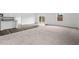 Open-concept living area with carpet flooring transitioning to kitchen area at 260 Logan Creek Dr, Zebulon, NC 27597