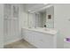 Bright bathroom featuring double sinks, a large mirror, and classic white cabinetry at 28 W Madison, Pittsboro, NC 27312