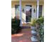 Inviting front porch with brick walkway and decorative plants at 28 W Madison, Pittsboro, NC 27312