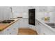 Well-equipped kitchen with white cabinets, island, built-in appliances, and subway tile backsplash at 28 W Madison, Pittsboro, NC 27312