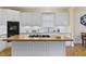 Updated kitchen featuring stainless steel appliances, cooktop island and ample storage at 28 W Madison, Pittsboro, NC 27312