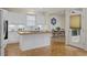 Modern kitchen with white cabinetry, island, and a view to the dining area at 28 W Madison, Pittsboro, NC 27312