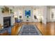 Bright living room featuring hardwood floors, large windows, and a classic fireplace at 28 W Madison, Pittsboro, NC 27312