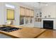Kitchen island overlooking cozy living room with fireplace and built-in shelves at 28 W Madison, Pittsboro, NC 27312