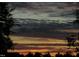 Striking sunset with layers of clouds, framed by silhouetted trees, creating a tranquil atmosphere at 28 W Madison, Pittsboro, NC 27312