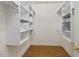 Well-organized walk-in closet featuring custom shelving and hardwood floors at 28 W Madison, Pittsboro, NC 27312