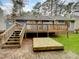 View of the home's wooden deck with stairs leading to the ground and a freshly constructed elevated platform at 2836 Thurrock Dr, Apex, NC 27539