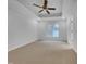 Spacious primary bedroom features neutral walls, ceiling fan, trey ceilings, and natural light at 2836 Thurrock Dr, Apex, NC 27539