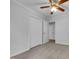 This bedroom features a ceiling fan, neutral carpet, multiple closets, and an adjoining doorway at 2836 Thurrock Dr, Apex, NC 27539