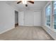 Neutral bedroom features include a ceiling fan, large window and a closet for ample storage at 2836 Thurrock Dr, Apex, NC 27539