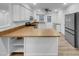 Open-concept kitchen with white cabinetry, stainless steel appliances, and a peninsula at 2836 Thurrock Dr, Apex, NC 27539