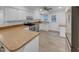 Kitchen features sleek appliances, white cabinetry, and ample countertop space at 2836 Thurrock Dr, Apex, NC 27539