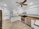 Spacious kitchen featuring white cabinets, stainless steel appliances, and plenty of counter space at 2836 Thurrock Dr, Apex, NC 27539