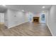 Spacious living room with wood-burning fireplace and natural light at 2836 Thurrock Dr, Apex, NC 27539