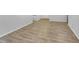 Expansive room featuring luxury vinyl plank flooring and crisp, clean walls at 2836 Thurrock Dr, Apex, NC 27539