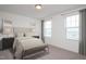 Stylized bedroom featuring large windows, neutral decor, and modern lighting at 316 Arch Canyon Cir, Zebulon, NC 27597