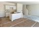 Bright, unfinished kitchen awaiting appliances, featuring fresh paint, new flooring, and a central island at 316 Arch Canyon Cir, Zebulon, NC 27597