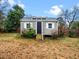 Charming shed with gray siding, metal roof, white trim, and small wooden front porch at 326 Hester St, Knightdale, NC 27545