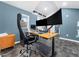 Well-lit home office features two monitors, ergonomic desk, and comfortable chair at 326 Hester St, Knightdale, NC 27545