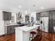 Open kitchen featuring stainless steel appliances, white countertops, and hardwood floors at 326 Hester St, Knightdale, NC 27545