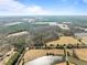 Expansive aerial view of the land including grassy fields, forests, and bodies of water at 4051 Silk Hope Gum Springs Rd, Pittsboro, NC 27312