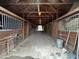 Spacious horse barn interior with multiple stalls, providing ample room for animals at 4051 Silk Hope Gum Springs Rd, Pittsboro, NC 27312