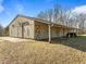 A large barn with multiple doors, and a shed section for storage at 4051 Silk Hope Gum Springs Rd, Pittsboro, NC 27312