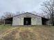 Exterior view of open barn, highlighting its spacious interior and potential for storage or livestock at 4051 Silk Hope Gum Springs Rd, Pittsboro, NC 27312