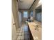 Bathroom with patterned floor, single sink vanity, and gray shower curtain at 4051 Silk Hope Gum Springs Rd, Pittsboro, NC 27312