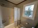 Bathroom showcasing a shower-tub combination with a tiled backsplash and a window at 4051 Silk Hope Gum Springs Rd, Pittsboro, NC 27312