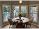 Dining room with a bay window overlooking a patio and pool at 4051 Silk Hope Gum Springs Rd, Pittsboro, NC 27312