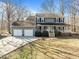 Charming home with a large porch, two-car garage, and well-maintained front yard at 4051 Silk Hope Gum Springs Rd, Pittsboro, NC 27312