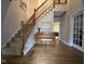Inviting foyer with hardwood floors, staircase, and space for a piano at 4051 Silk Hope Gum Springs Rd, Pittsboro, NC 27312