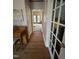 Foyer with hardwood floors, staircase and doorway looking into an adjacent room at 4051 Silk Hope Gum Springs Rd, Pittsboro, NC 27312