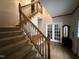 Welcoming foyer with a staircase, hardwood floors, and natural light at 4051 Silk Hope Gum Springs Rd, Pittsboro, NC 27312