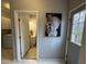 Hallway featuring a view into a full bathroom and a doorway to the exterior at 4051 Silk Hope Gum Springs Rd, Pittsboro, NC 27312