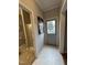 Hallway featuring a view into a bathroom with a shower and a doorway to the pool at 4051 Silk Hope Gum Springs Rd, Pittsboro, NC 27312