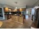 Bright kitchen with wood cabinets, dark countertops, and stainless steel appliances at 4051 Silk Hope Gum Springs Rd, Pittsboro, NC 27312
